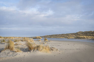 Netherlands, Friesland, Terschelling, Clouds over grassy sand dunes - KEBF02824