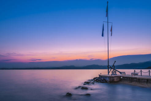 Italy, Veneto, Bardolino, Long exposure of marina on lake Garda at dusk - MHF00746
