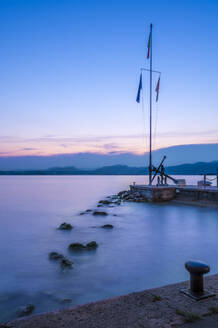 Italy, Veneto, Bardolino, Long exposure of marina on lake Garda at dusk - MHF00747