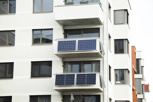 Deutschland, Baden-Württemberg, Freiburg im Breisgau, Sonnenkollektoren auf Balkonen eines modernen Mehrfamilienhauses - SGF02952