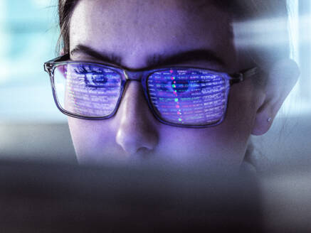 Businesswoman examining stock exchange data on computer - ABRF01124