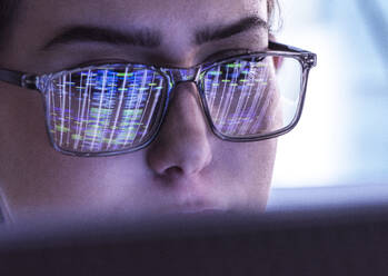 Scientist wearing eyeglasses and analyzing DNA data on computer - ABRF01128