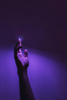 Human hand under purple neon lighting - EGHF00826