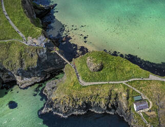 Aerial view of a rocky promontory along the coastline with cliffs in Nothern Ireland, United Kingdom. - AAEF25148