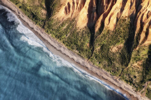 Aerial view of the rugged Sellicks Beach cliffs with blue ocean waves rolling onto the shore and green vegetation, Sellicks Beach, South Australia, Australia. - AAEF25237