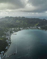 Luftaufnahme einer kleinen Stadt entlang der Bucht bei Sonnenaufgang auf Providencia und der Insel Santa Catalina, Archipel von Sankt Andreas, Kolumbien. - AAEF25331