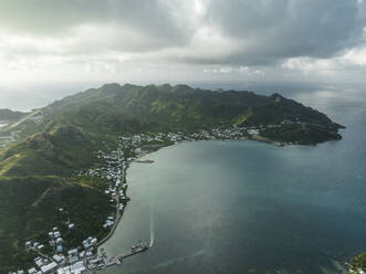Aerial view of a small town along the bay at sunrise on Providencia and Santa Catalina Island, Archipelago of Saint Andrew, Colombia. - AAEF25332
