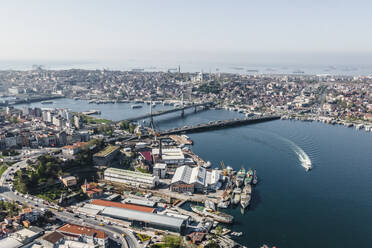 Aerial view of a boat sailing along the Golden Horn, the major waterway of the Bosphorus channel in Beyoglu district in Istanbul European side, Turkey. - AAEF25520