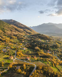 Aerial view of a mountains and hills landscape with vineyard and countryside houses at sunset in autumn colours, Irpinia, Avellino, Campania, Italy. - AAEF25742