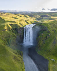 Aerial drone view of Skógafoss waterfall during sunrise in summer time, Southern Iceland. - AAEF25935