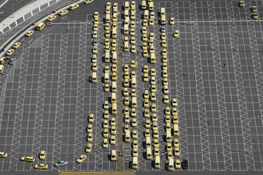 Aerial perspective of taxis lined up in airport car park, showcasing organized transportation services, Australia. - AAEF26000