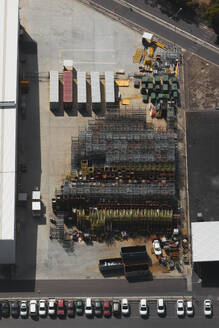 Aerial view of stacked hardware on a factory hardstand, revealing organised industrial materials, Australia. - AAEF26014