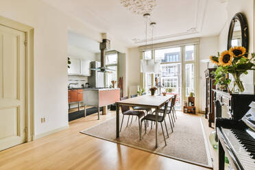 Helles und geräumiges Esszimmer mit angrenzender offener Küche und einem Klavier in einer modernen Wohnung. - ADSF52720