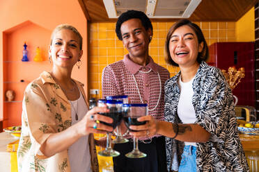 Group of friends bonding at home, LGBTQ and diversity concepts - Homosexual couple and fluid gender non binary young man with cross dressing clothing style having fun in the apartment, LGBT people concepts - DMDF09274