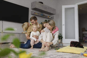 Happy family sitting together on floor at home - SEAF02234