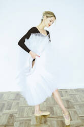 Ballerina practicing ballet dance with tutu in studio - YHF00099