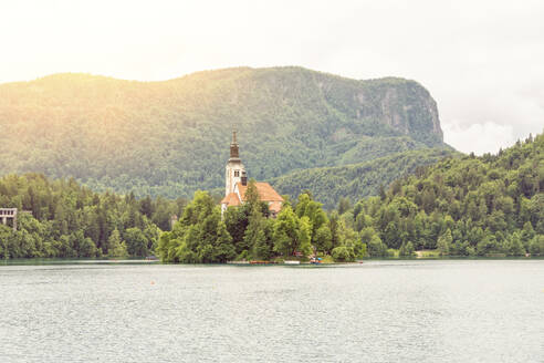 Slovenia, Upper Carniola, Bled, Summer sun setting over Bled island - TAMF04188