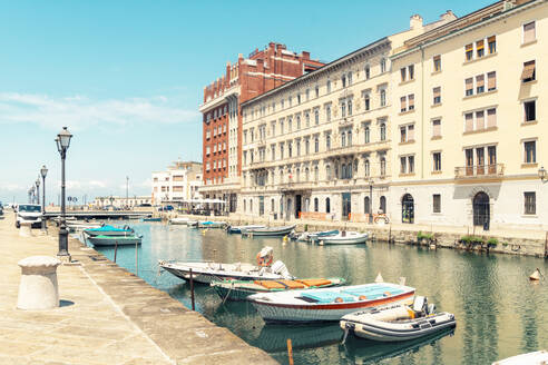 Italy, Friuli-Venezia Giulia, Trieste, Boats moored along Canal Grande in summer - TAMF04202