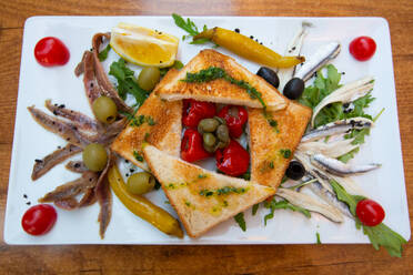Food Plate of Marinated and Salted Anchovies with Cherry Tomatoes, Olives, Stuffed Miniature Bell Peppers and Toast, Pula, Croatia, Europe - RHPLF31764