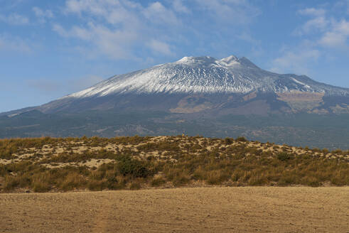 First snow covering the summit of Mount Etna volcano seen from inland, UNESCO World Heritage Site, Etna Park, Catania province, Sicily, Italy, Mediterranean, Europe - RHPLF31951