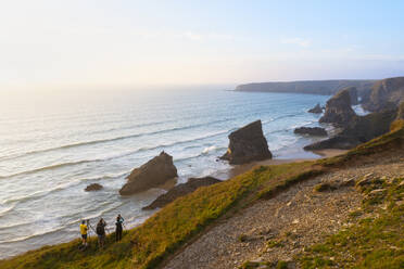 Aerial view at sunset of photographers at Carnewas and Bedruthan Steps, Bedruthan Steps, Newquay, Cornwall, England, United Kingdom, Europe - RHPLF31973