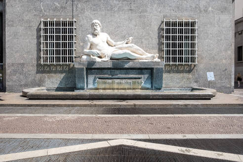 View of the Fountain of Po in Via Roma, executed by Umberto Baglioni, 1893-1965, and placed in 1939, the allegorical statue represents the River Po with a man lying on a pedestal, from which water flows, Turin, Piedmont, Italy, Europe - RHPLF32007