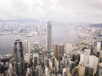 Modern skyscrapers in front of sea in Hong Kong city - MMPF01214