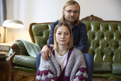 Woman with man sitting on sofa at home - SUF00728