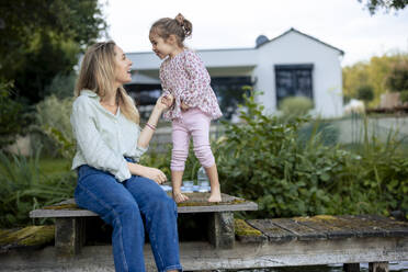 Happy daughter enjoying with mother on pier - JOSEF23217