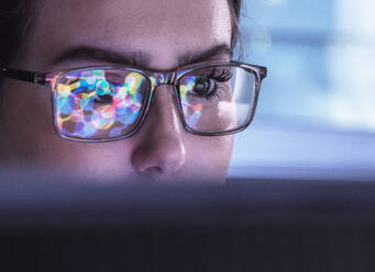 Scientist wearing eyeglasses and analyzing biochemical data on computer - ABRF01136