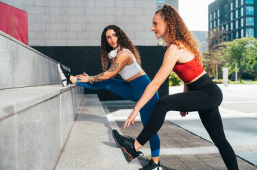 Lgbt couple training together outdoor. Runner real couple making sport in an urban area of the city. Concepts of sports and lifestyle - DMDF09823