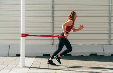 Beautiful sporty girl training outdoor in an urban area of the city - DMDF09847