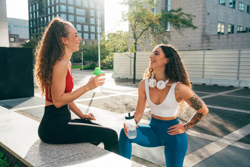 Ein schwules Paar trainiert zusammen im Freien. Ein echtes Läuferpaar treibt Sport in einem urbanen Gebiet der Stadt. Konzepte von Sport und Lifestyle - DMDF09863