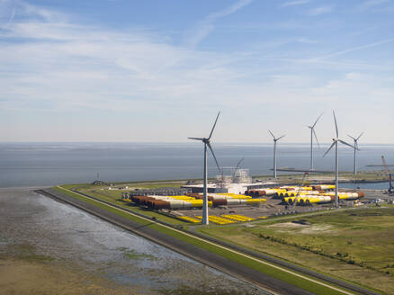 Niederlande, Provinz Groningen, Eemshaven, Luftaufnahme von Windkraftanlagen vor dem Seehafen - MKJF00007