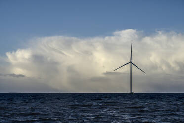 Netherlands, Flevoland, Lelystad, Thick clouds over offshore wind farm in IJsselmeer - MKJF00019