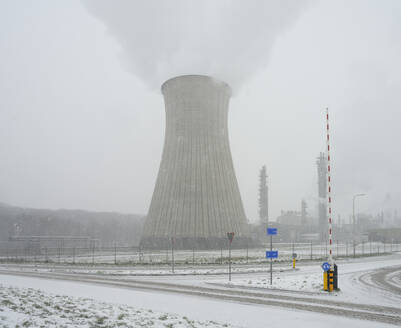 Netherlands, Limburg, Geleen, Cooling tower emitting large cloud of vapor in winter - MKJF00025