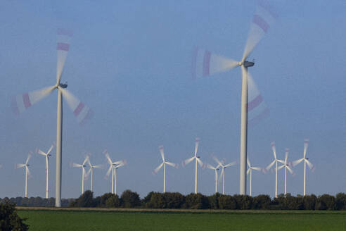 Wind turbines spinning against sky - JATF01383