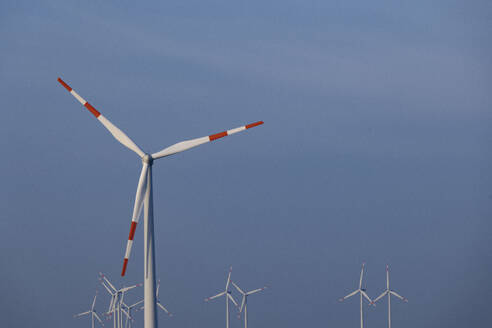 Wind farm turbines standing against sky - JATF01389