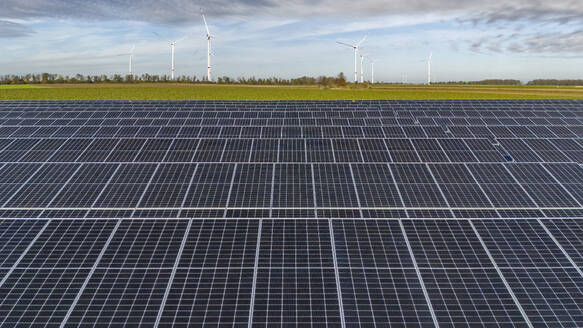 Solar power station with wind farm in background - JATF01392