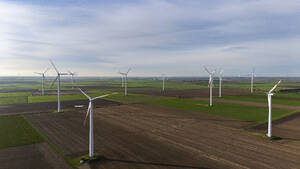 Aerial view of wind turbines on plowed field - JATF01394