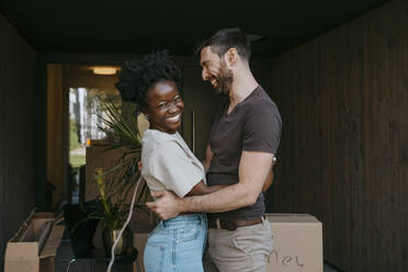 Portrait of cheerful woman laughing with multiracial boyfriend - MASF42475