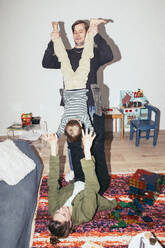 Playful parents having fun with son at home - MASF42523