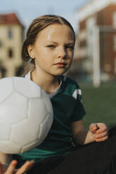 Portrait of female athlete with soccer ball at sports field - MASF42691