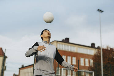 Jugendlicher spielt mit Sportball gegen den Himmel - MASF42792