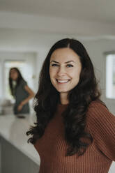 Portrait of smiling mature woman standing at home - MASF42861