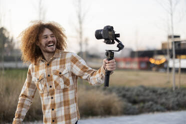 Happy influencer vlogging through camera - JCCMF11172