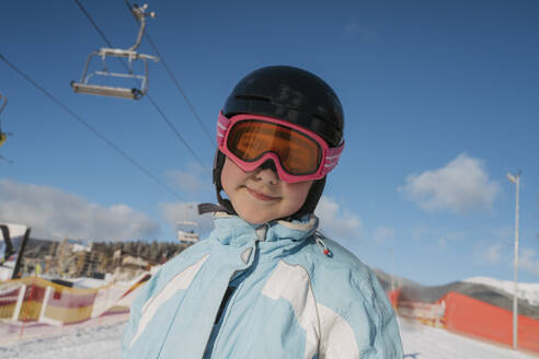 Girl wearing ski goggles at resort - OSF02391