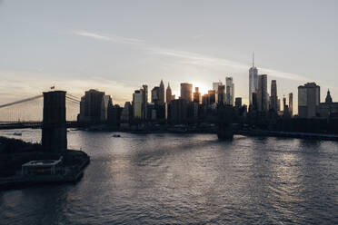 USA, New York State, New York City, Brooklyn Bridge and Manhattan skyline at sunset - NGF00822