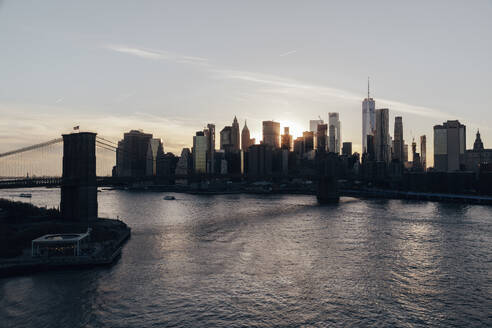USA, New York State, New York City, Brooklyn Bridge and Manhattan skyline at sunset - NGF00822