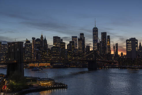 USA, New York State, New York City, Brooklyn Bridge and Manhattan skyline at dusk - NGF00824